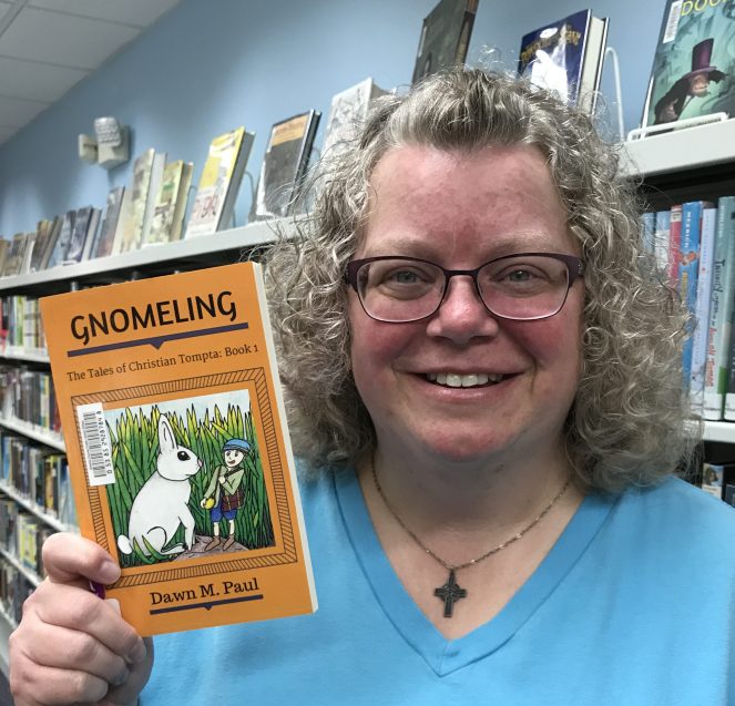 Dawn with Her First Book in a Library